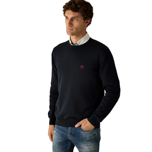 Man wearing Campione navy crewneck sweater layered over a shirt, styled with denim jeans, Kayagan, Lebanon