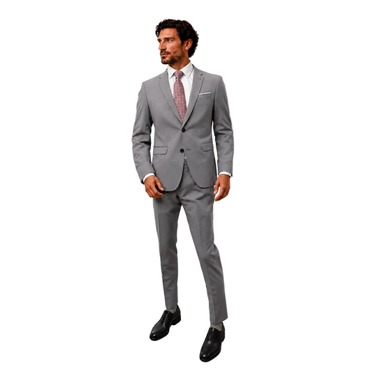 A man standing against a blank white background modeling a Digel men's 2-piece ceremony suit in light grey. The formal outfit features a tailored single-breasted two-button blazer with a pocket square, matching slim flat-front dress trousers, a white shirt, a patterned red tie, and polished black leather oxford dress shoes.