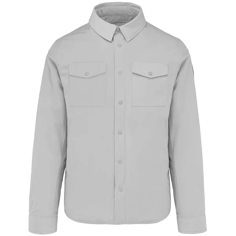 A flat-lay studio product shot of a Bomboogie men's technical fabric overshirt in a clean light grey shade, centered on a white background. The shirt jacket features a classic pointed collar, a snap-button front closure, two matching rectangular flap chest pockets, and buttoned long-sleeve cuffs.