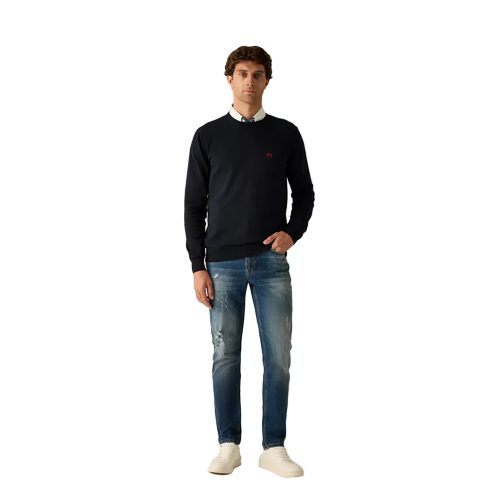 Man wearing Campione navy crewneck sweater layered over a shirt, styled with denim jeans, Kayagan, Lebanon