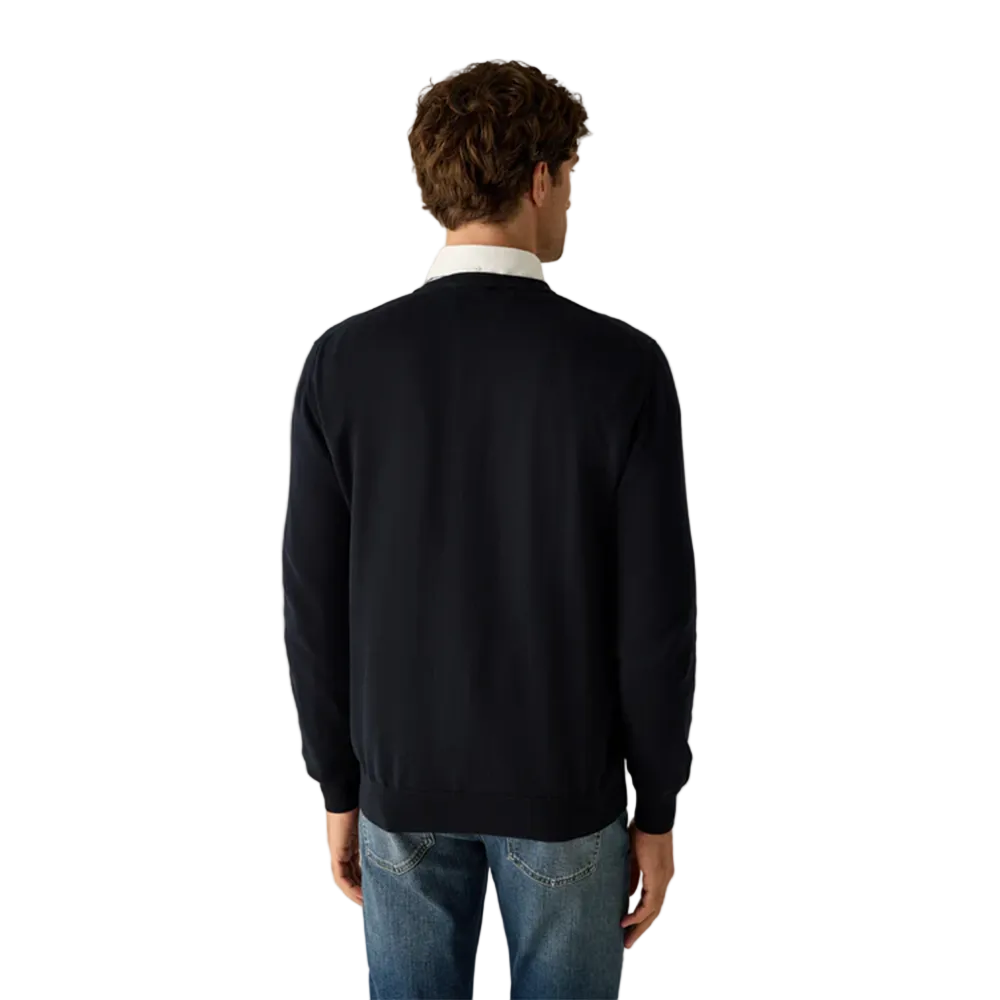 Man wearing Campione navy crewneck sweater layered over a shirt, styled with denim jeans, Kayagan, Lebanon