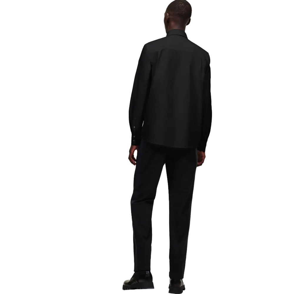 A front view of a model wearing a crisp black long-sleeve Karl Lagerfeld Ikon Poplin Shirt with a button-down collar and small embroidered chest logo.