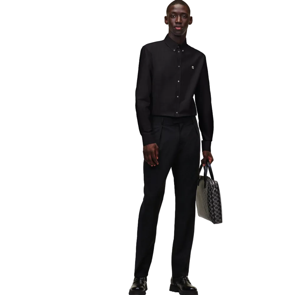 A front view of a model wearing a crisp black long-sleeve Karl Lagerfeld Ikon Poplin Shirt with a button-down collar and small embroidered chest logo.