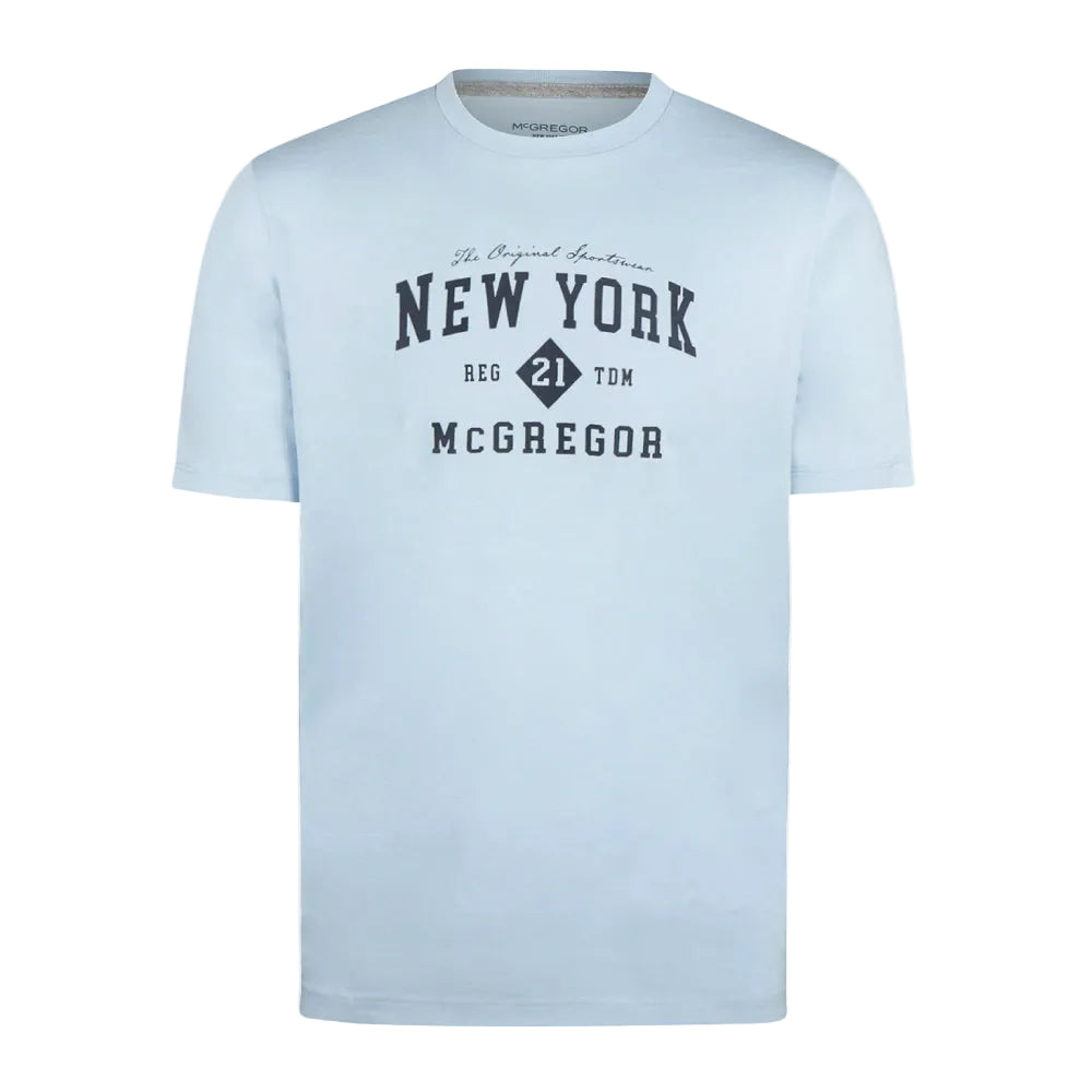 Model wearing a McGregor men's light blue NY graphic crew neck T-shirt with a vintage New York print and short sleeves on a white background.