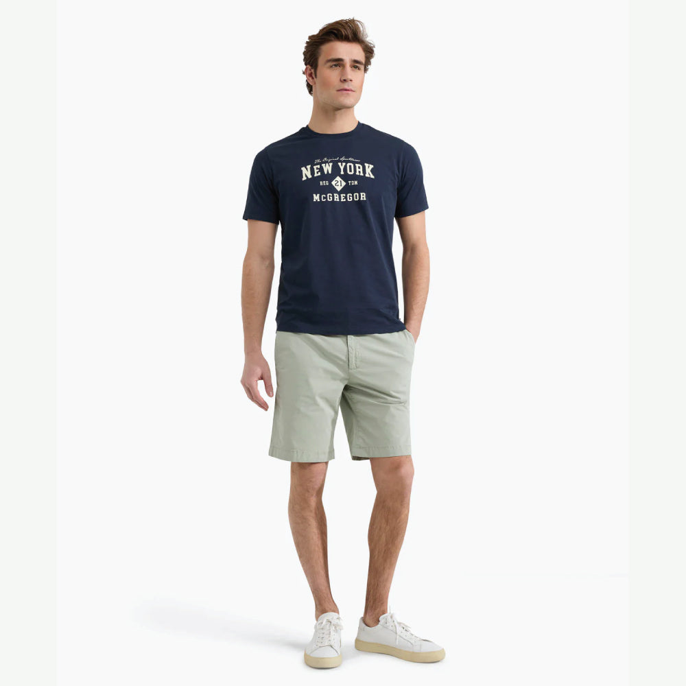 Model wearing a McGregor men's navy NY graphic crew neck T-shirt with a vintage New York print and short sleeves on a white background.