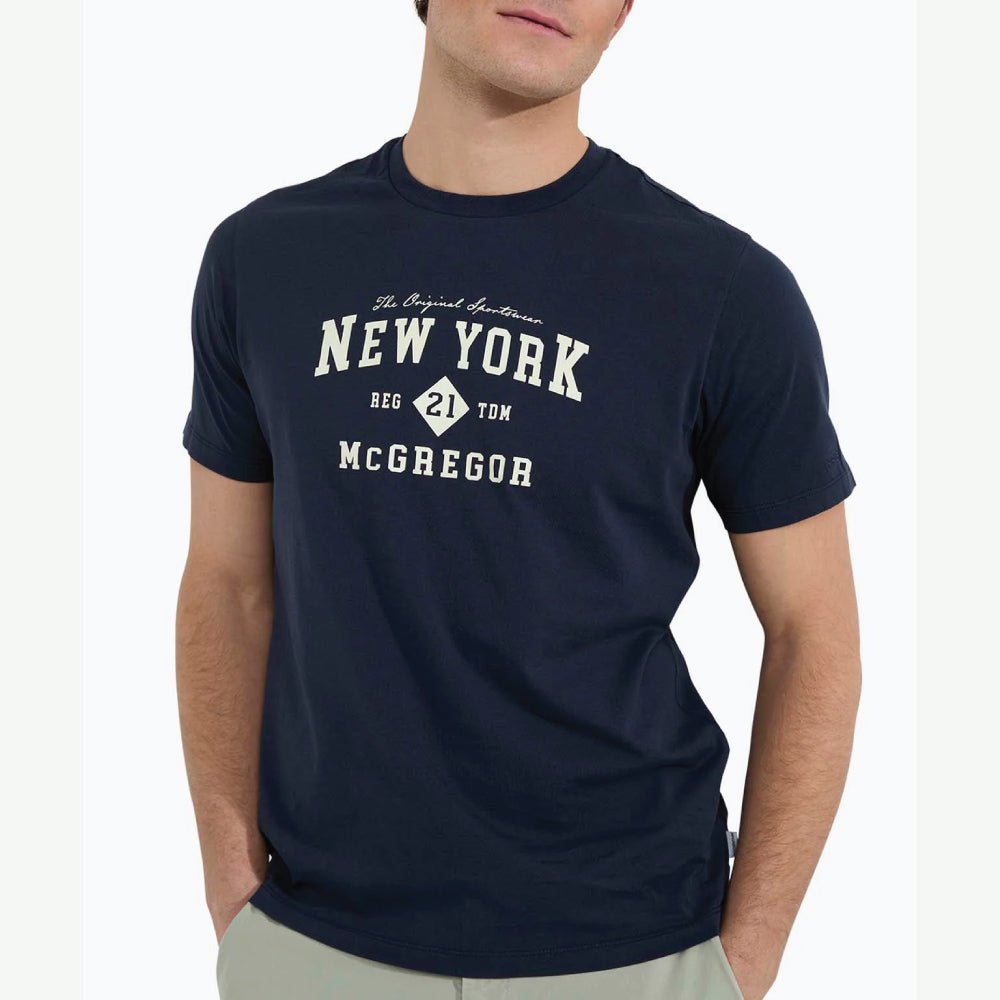 Model wearing a McGregor men's navy NY graphic crew neck T-shirt with a vintage New York print and short sleeves on a white background.