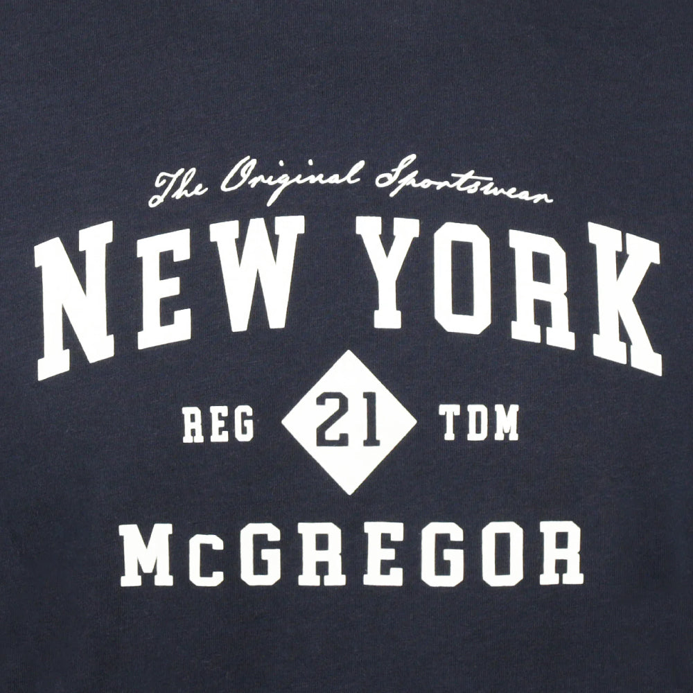 Model wearing a McGregor men's navy NY graphic crew neck T-shirt with a vintage New York print and short sleeves on a white background.