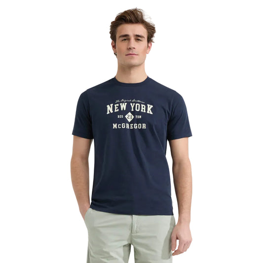 Model wearing a McGregor men's navy NY graphic crew neck T-shirt with a vintage New York print and short sleeves on a white background.