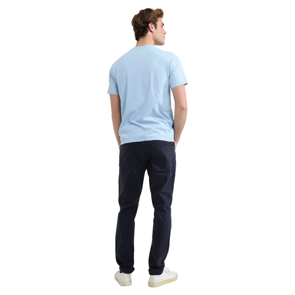 Model wearing a McGregor men's light blue NY graphic crew neck T-shirt with a vintage New York print and short sleeves on a white background.