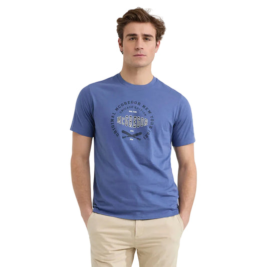 Model wearing a McGregor men's blue Original Print crew neck T-shirt with a vintage logo graphic and short sleeves on a white background.