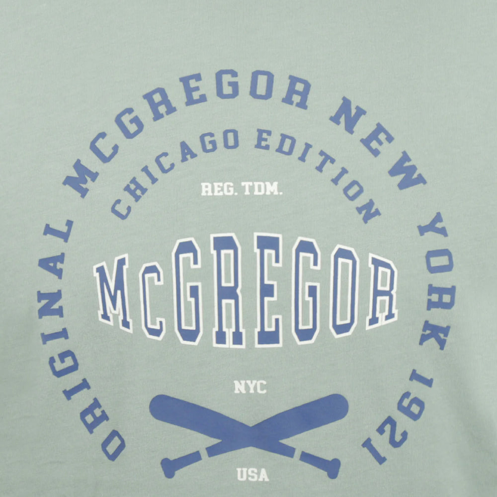 Man wearing a McGregor men's Ice green Original Print crew neck T-shirt with a vintage logo graphic and short sleeves, Kayagan