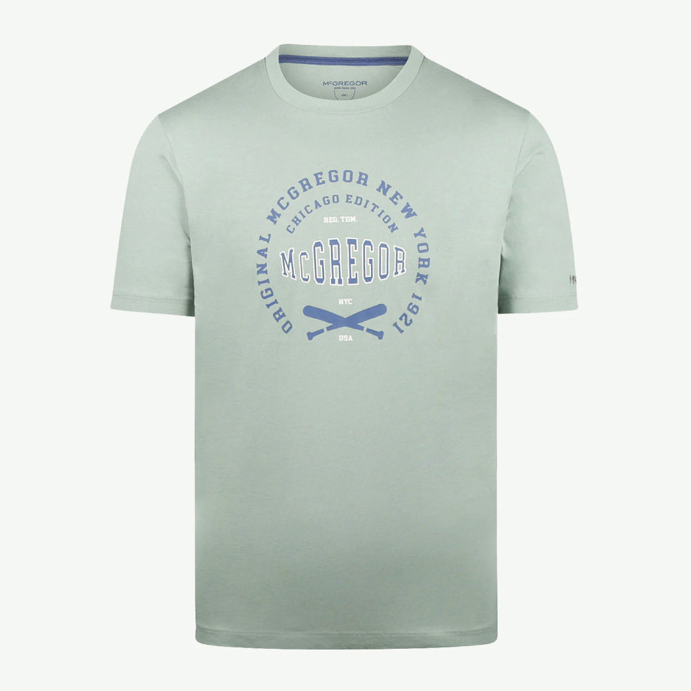 Man wearing a McGregor men's Ice green Original Print crew neck T-shirt with a vintage logo graphic and short sleeves, Kayagan