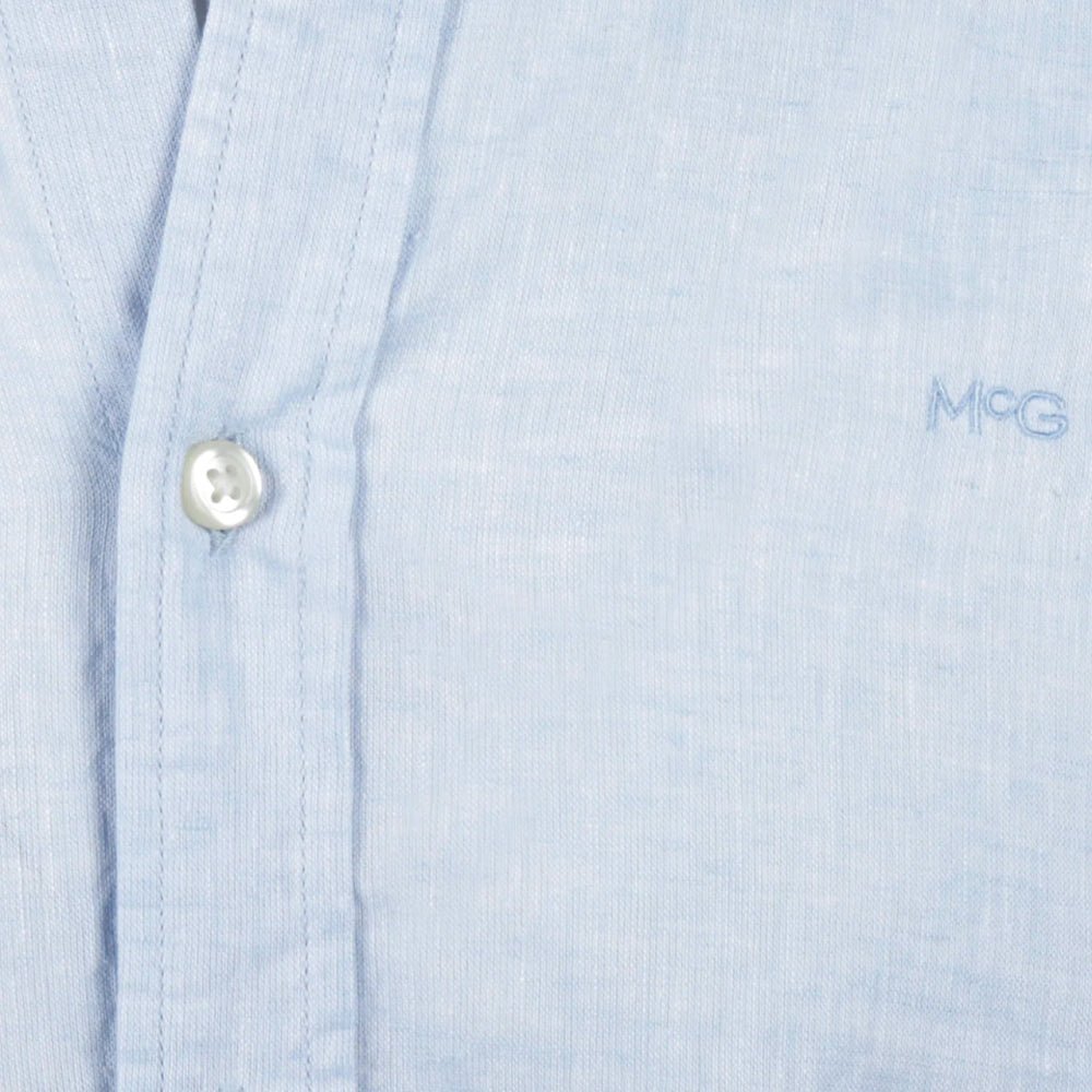 Model wearing a McGregor men's light blue linen cotton button-down shirt with long sleeves and a classic collar on a white background.