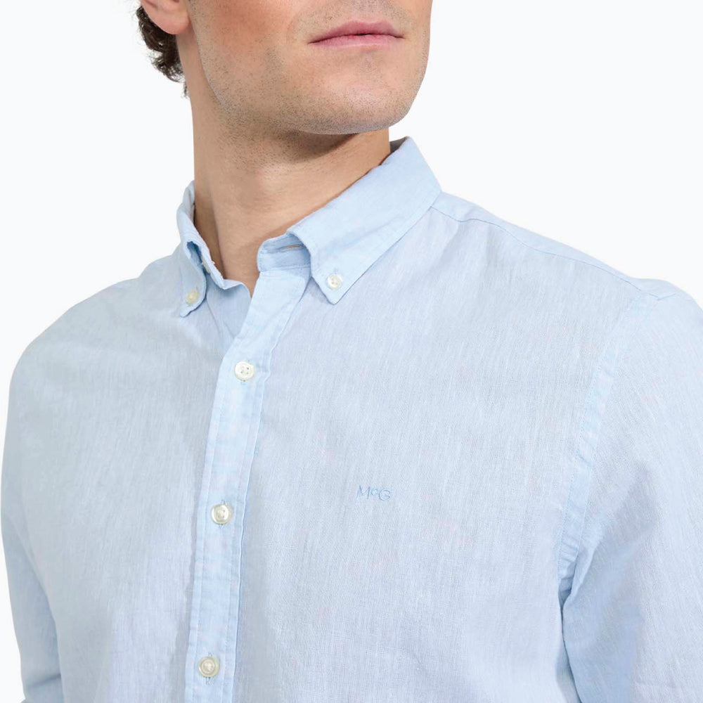 Model wearing a McGregor men's light blue linen cotton button-down shirt with long sleeves and a classic collar on a white background.