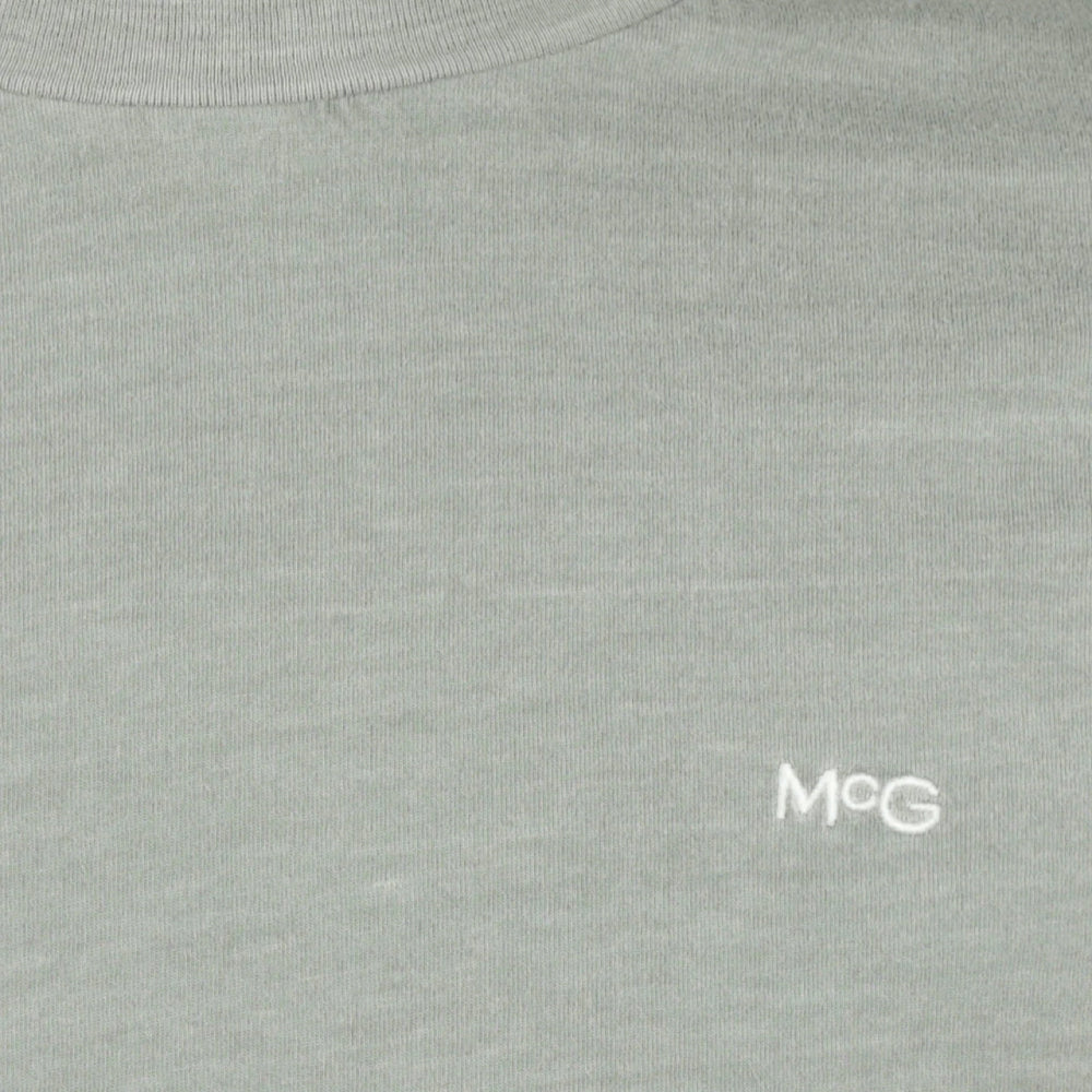 Front view of a McGregor men's garment dyed crew neck T-shirt in ice green with short sleeves and embroidered chest logo on a white background.