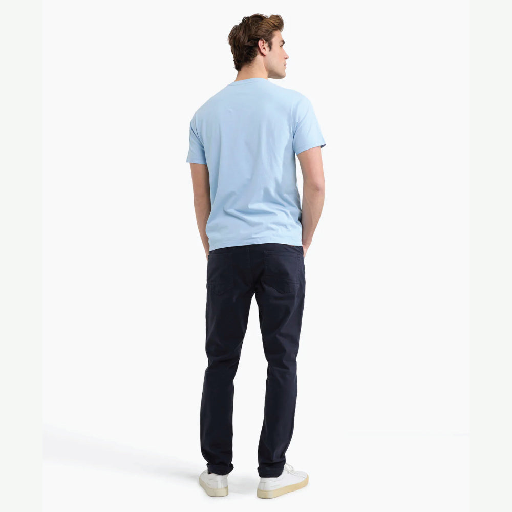 Model wearing a McGregor men's light blue NY graphic crew neck T-shirt with a vintage New York print and short sleeves on a white background.