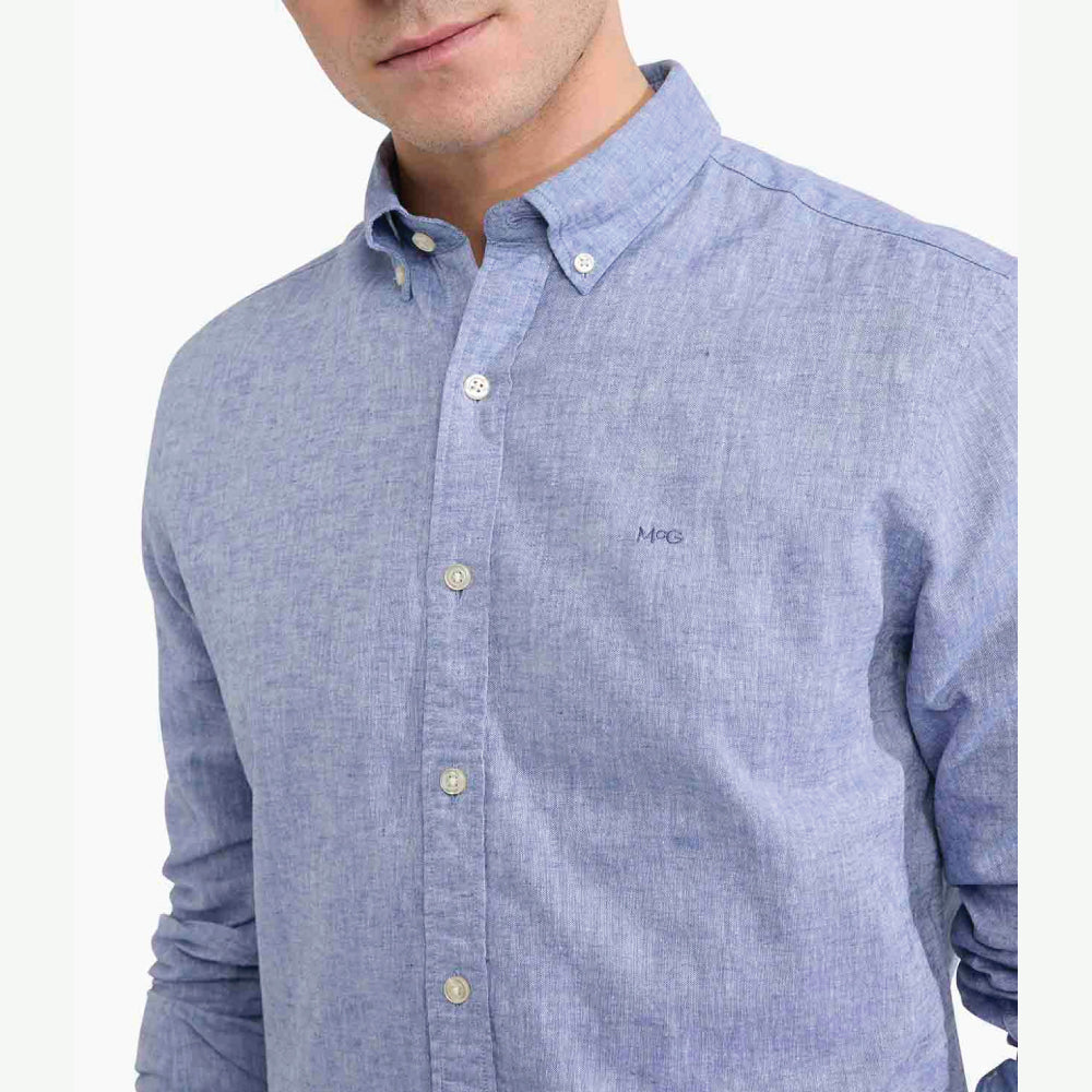 Model wearing a McGregor men's blue linen cotton button-down shirt with long sleeves and a classic collar on a white background.
