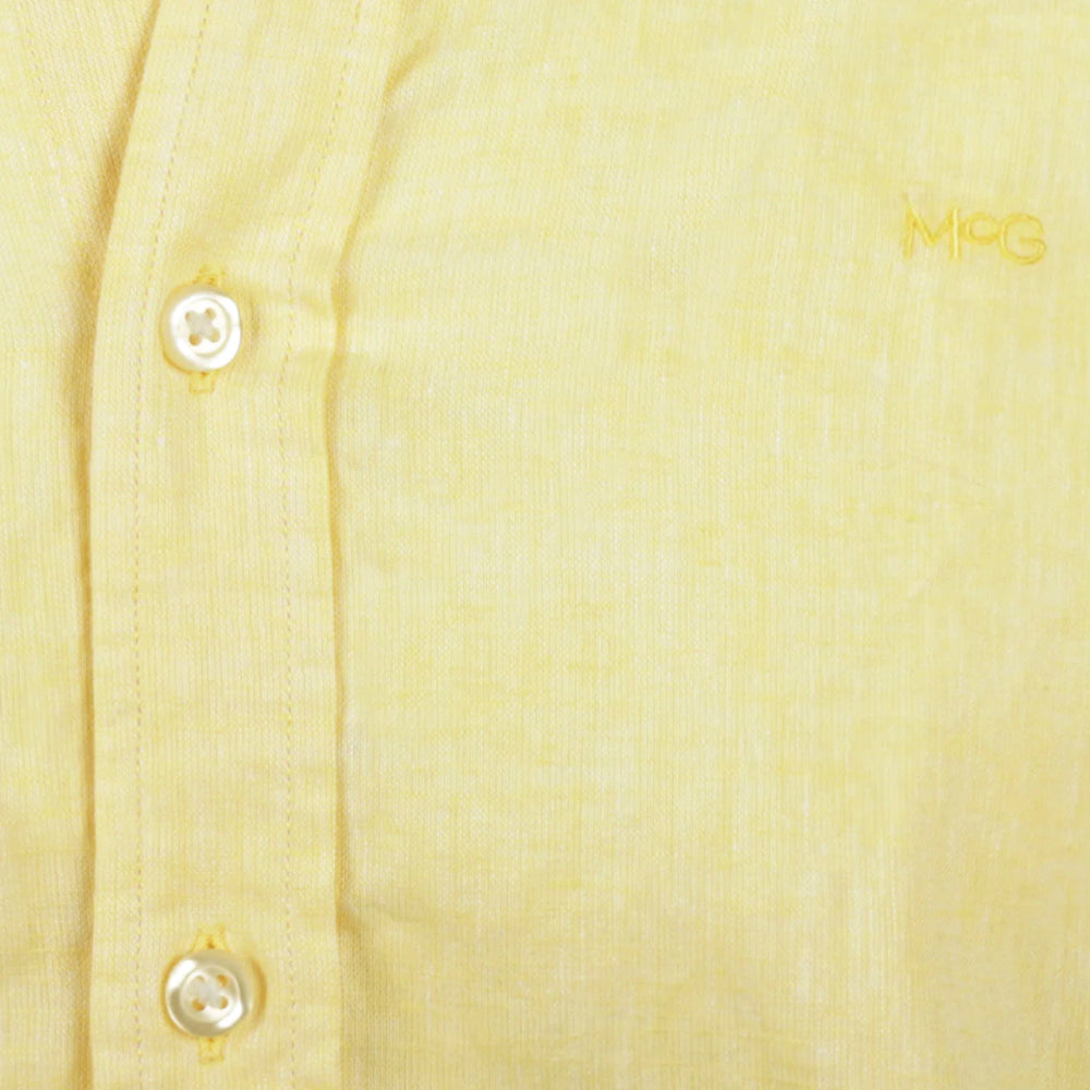 Close-up of a model wearing a McGregor men's lemon  yellow linen cotton button-up shirt with a button-down collar.