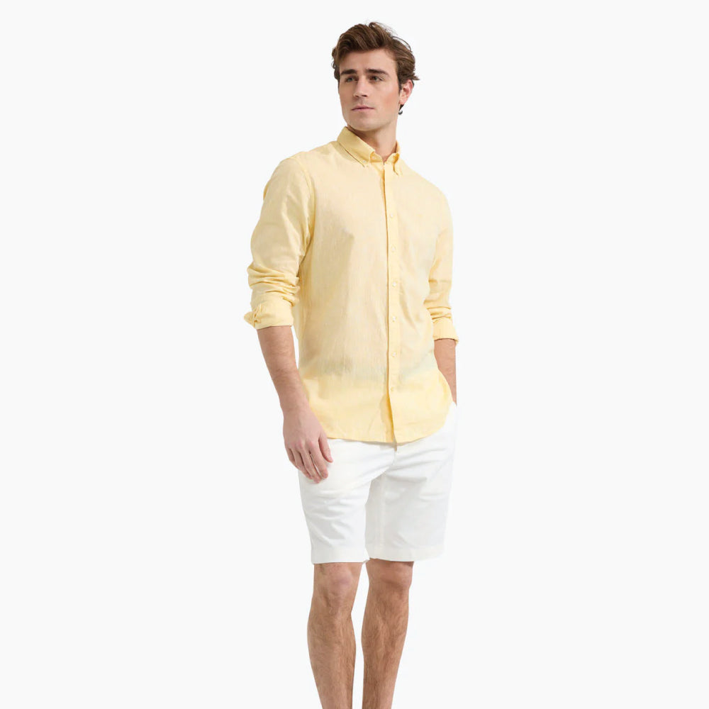 Close-up of a model wearing a McGregor men's lemon  yellow linen cotton button-up shirt with a button-down collar.
