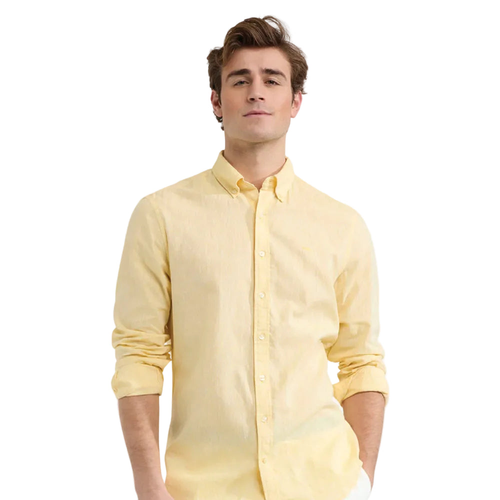 Close-up of a model wearing a McGregor men's lemon  yellow linen cotton button-up shirt with a button-down collar.