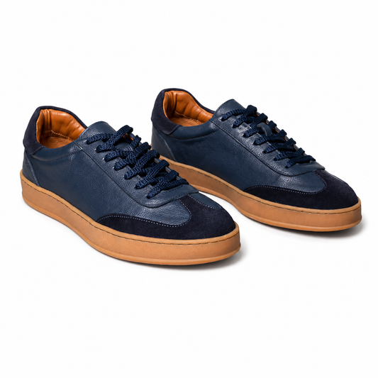 Pair of Pedro navy blue sneakers with brown soles 