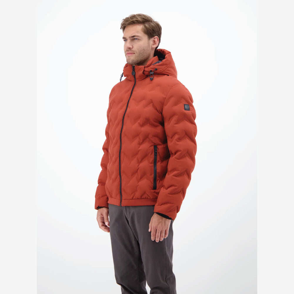 Man wearing a rust, burnt red Lerros quilted jacket with hood, styled with grey trousers, front view studio photo