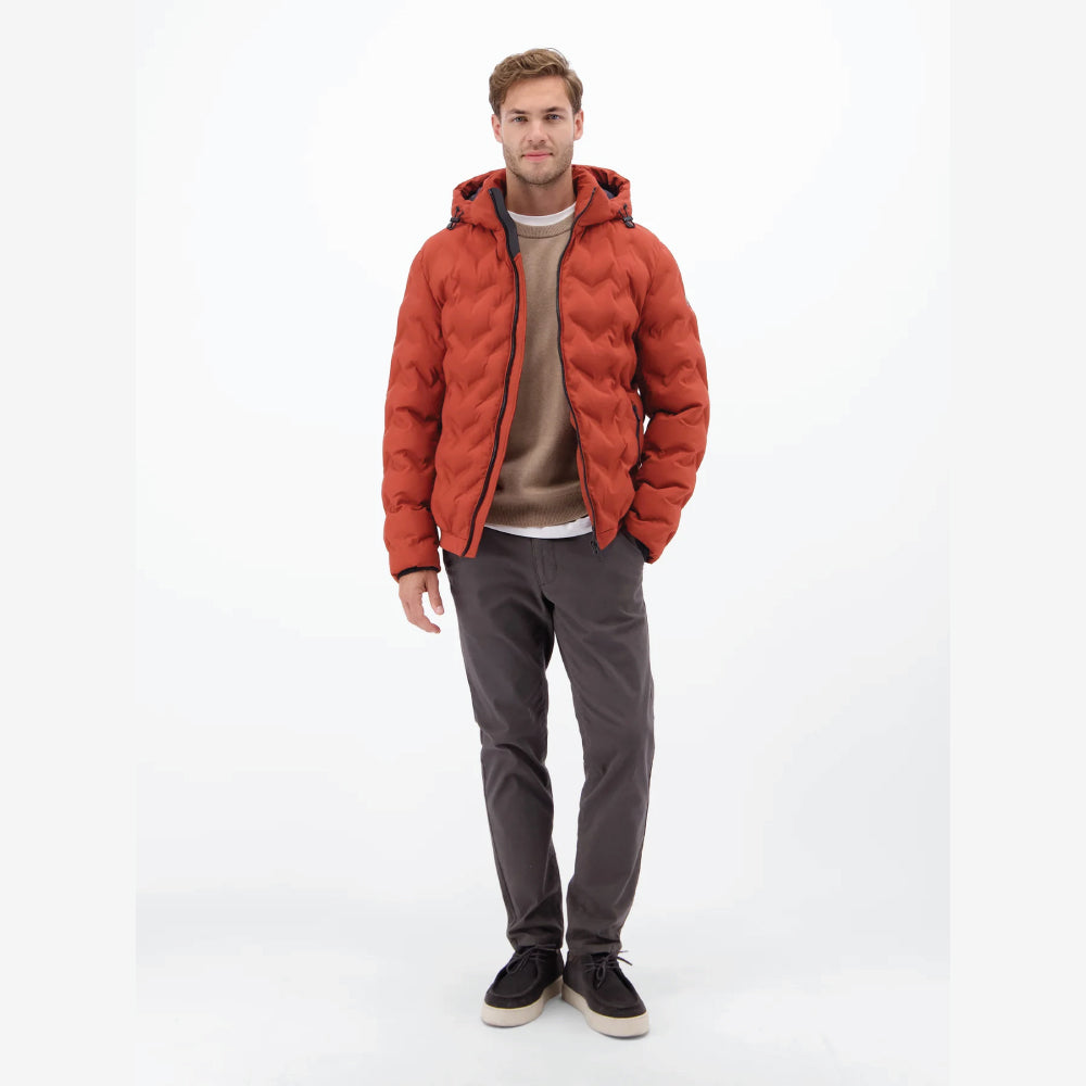 Man wearing a rust, burnt red Lerros quilted jacket with hood, styled with grey trousers, front view studio photo