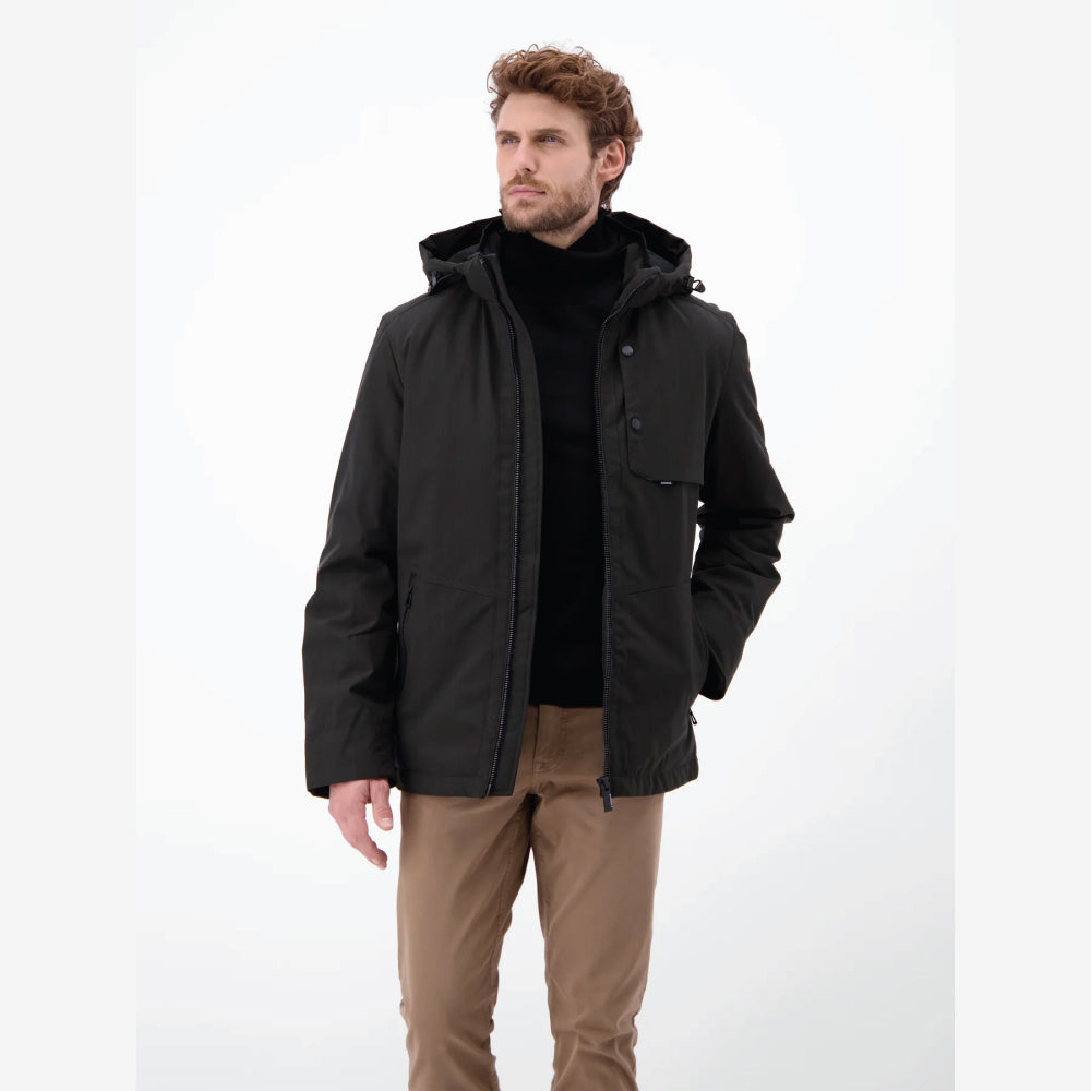 Man wearing a black Lerros structured blouson jacket with hood, styled with beige chinos, front view studio photo, at Kayagan