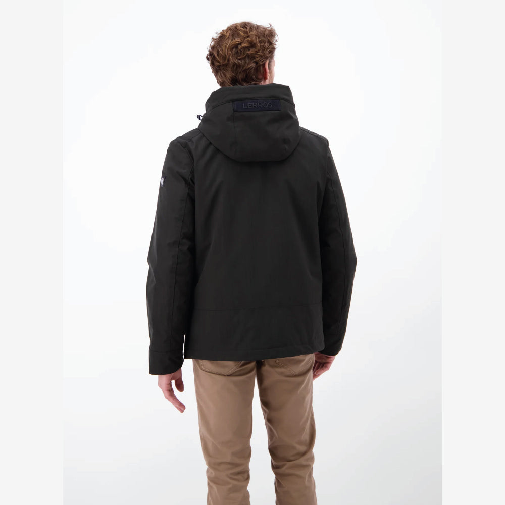 Man wearing a black Lerros structured blouson jacket with hood, styled with beige chinos, front view studio photo, at Kayagan