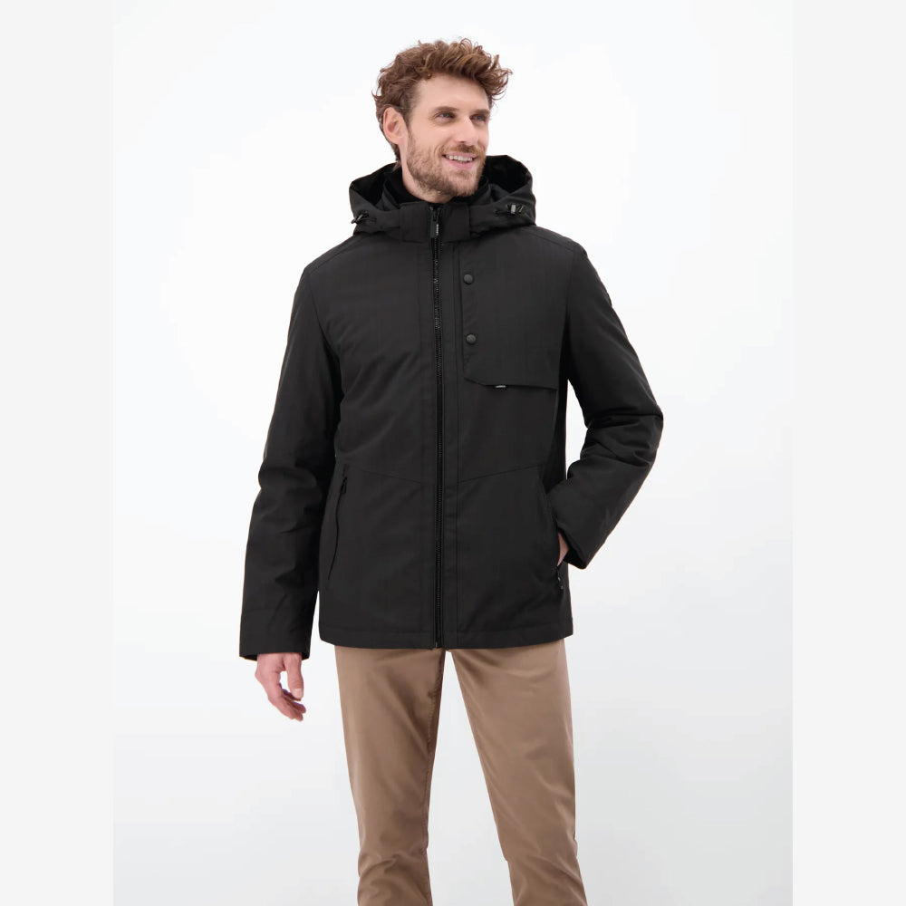 Man wearing a black Lerros structured blouson jacket with hood, styled with beige chinos, front view studio photo, at Kayagan