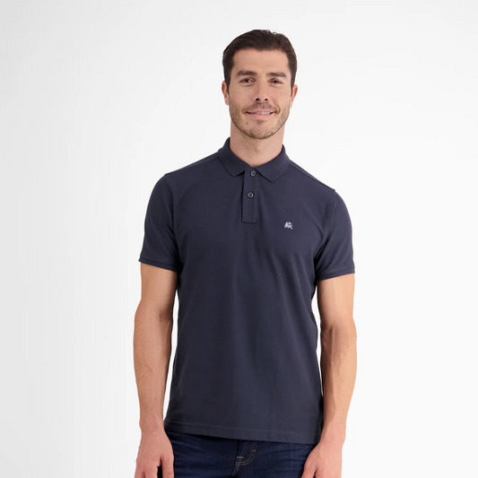 Man wearing a navy Lerros classic polo shirt in Cool and Dry piqué fabric, front view studio photo
