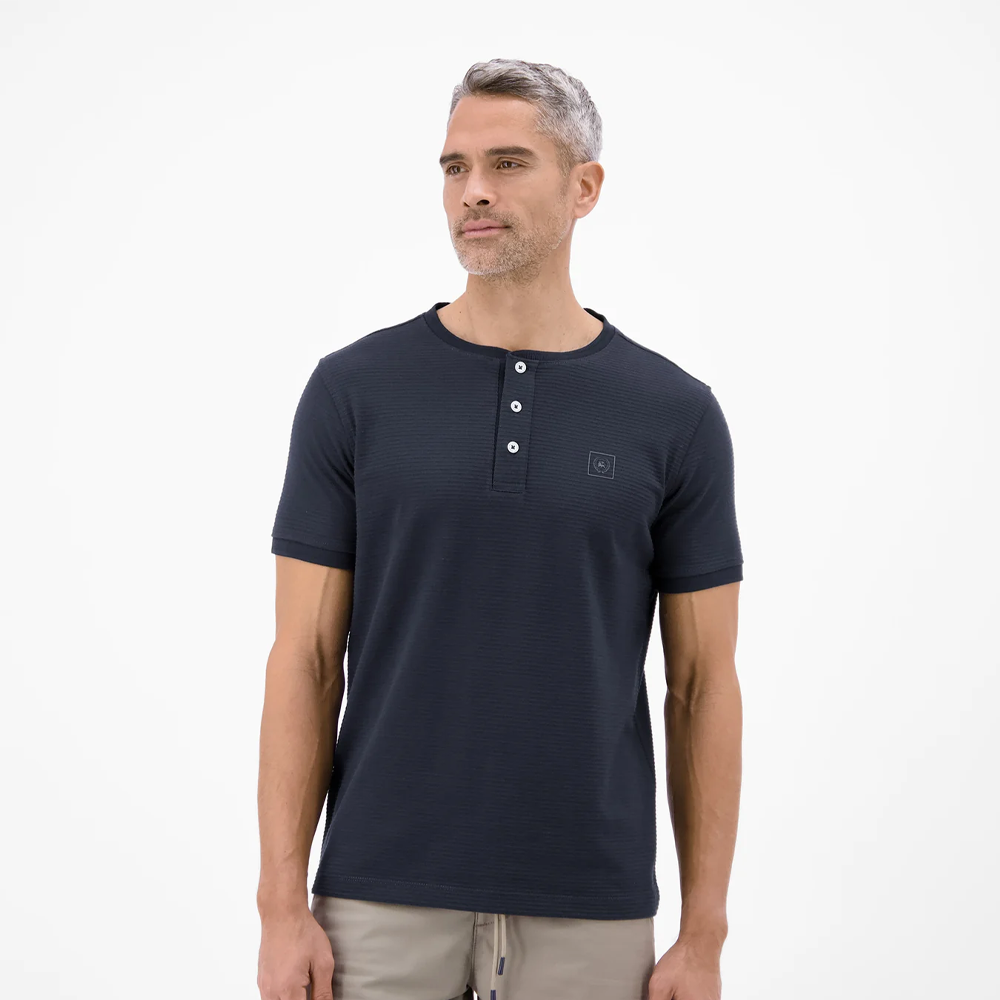 Man wearing a navy Lerros t-shirt with round collar, button placket, and Cool and Dry fabric, front view studio photo, available at ayagan