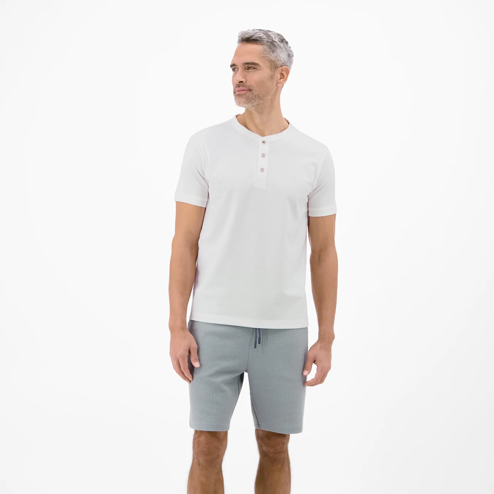 Man wearing a white Lerros t-shirt with round collar, button placket, and Cool and Dry fabric, front view studio photo, available at ayagan