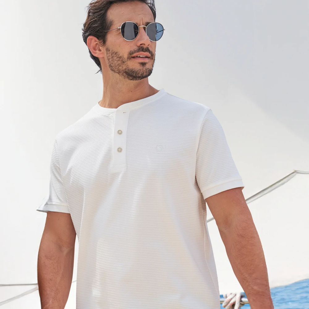 Man wearing a white Lerros t-shirt with round collar, button placket, and Cool and Dry fabric, front view studio photo, available at ayagan