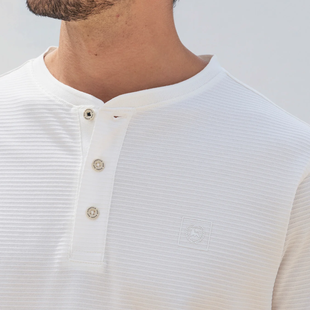 Man wearing a white Lerros t-shirt with round collar, button placket, and Cool and Dry fabric, front view studio photo, available at ayagan