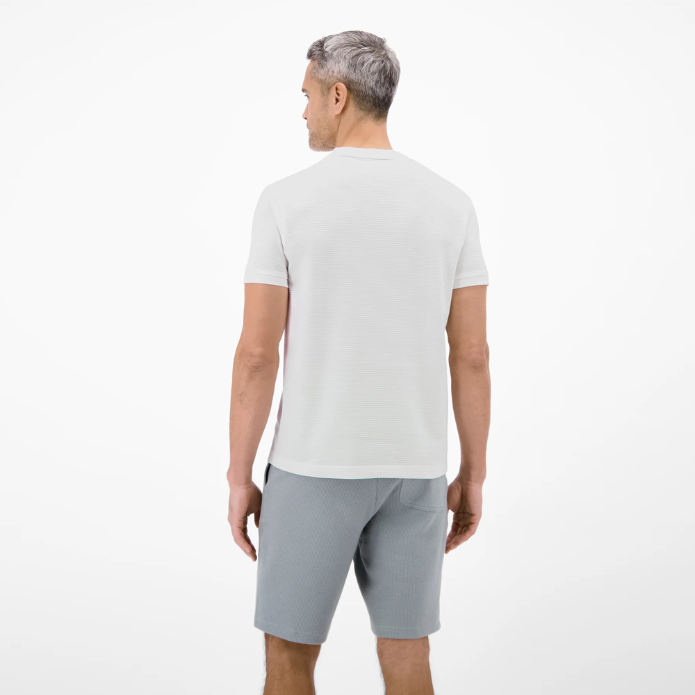 Man wearing a white Lerros t-shirt with round collar, button placket, and Cool and Dry fabric, back view studio photo, available at ayagan