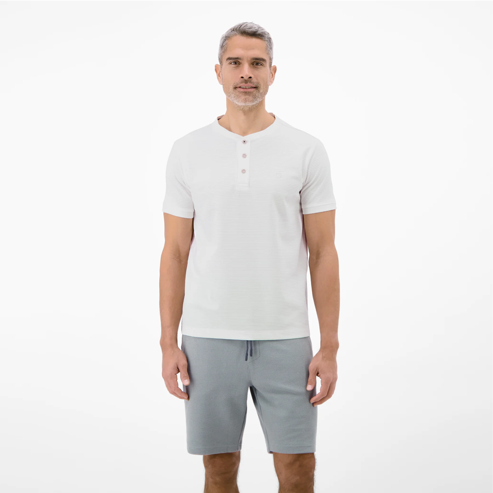 Man wearing a white Lerros t-shirt with round collar, button placket, and Cool and Dry fabric, front view studio photo, available at ayagan
