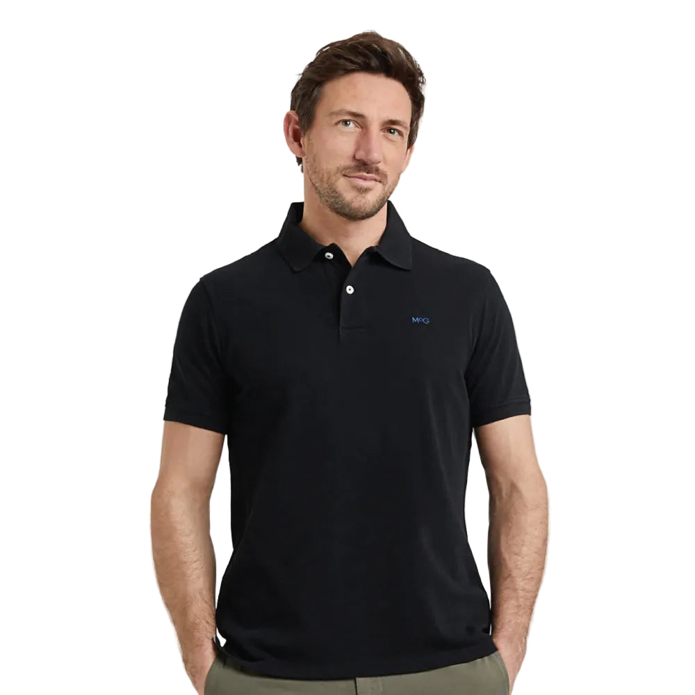 Model wearing a McGregor men's classic regular fit black polo shirt with a ribbed collar and short sleeves on a white background.