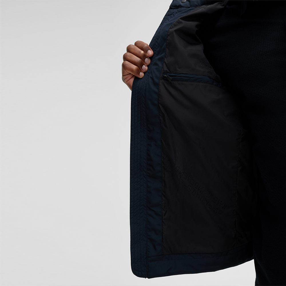 Man wearing Strellson Flex Cross Rockston dark blue biker jacket with stand collar and chest zip pocket