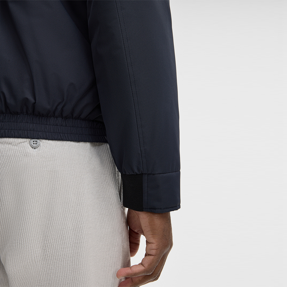 Man wearing Strellson dark blue light jacket with stand collar and front zip closure