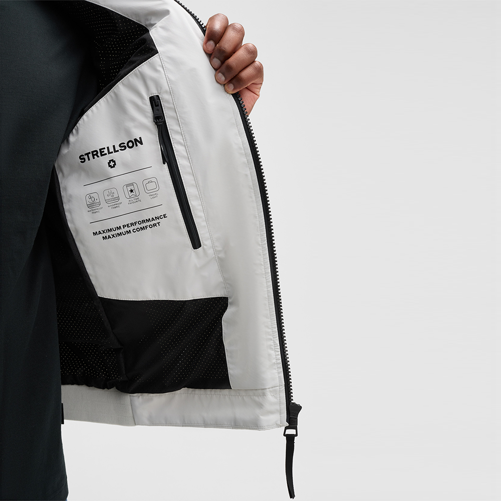 Man wearing Strellson Lucca Windbreaker Jacket in off-white with stand collar and zip front, and embroidered logo on the left arm, Kayagan