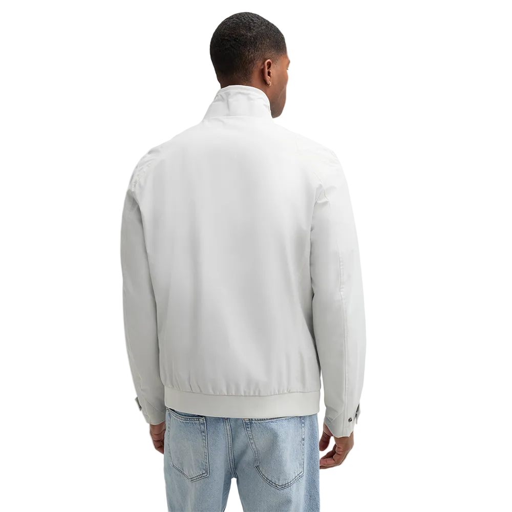 Man wearing Strellson Lucca Windbreaker Jacket in off-white with stand collar and zip front, and embroidered logo on the left arm, Kayagan