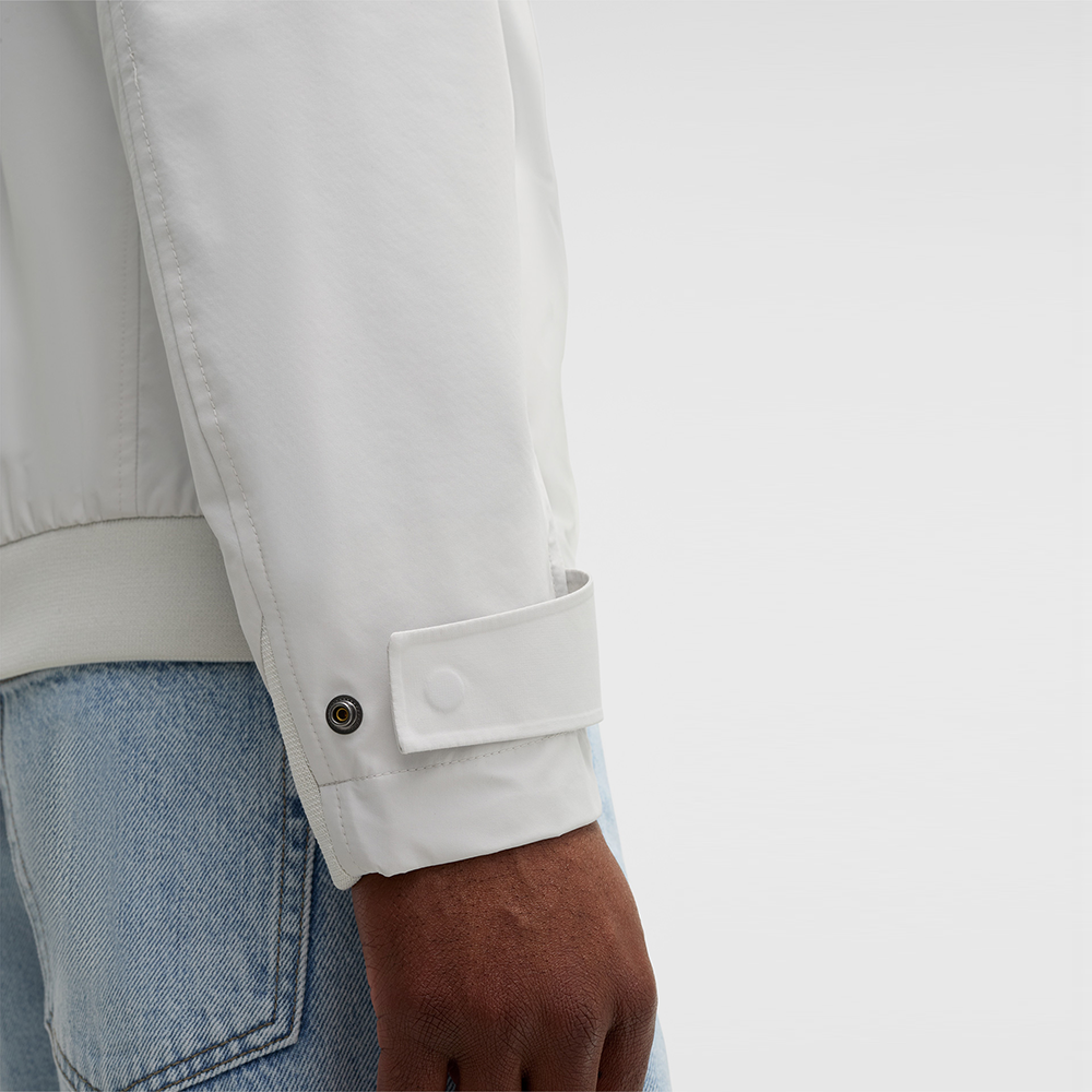 Man wearing Strellson Lucca Windbreaker Jacket in off-white with stand collar and zip front, and embroidered logo on the left arm, Kayagan